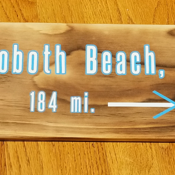 Rehoboth Beach, DE mileage sign